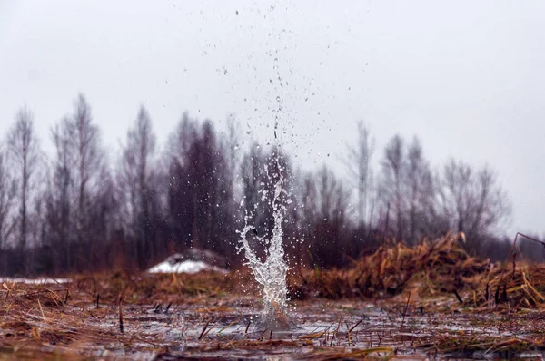 Explosion of firecrackers in the water, flying splashes in different directions.