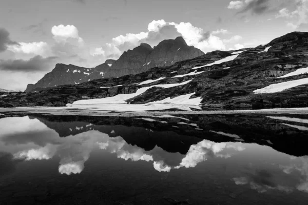 black and white photo of majestic mountains backdrop