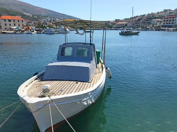 Small boat with wooden deck in Croatian marina