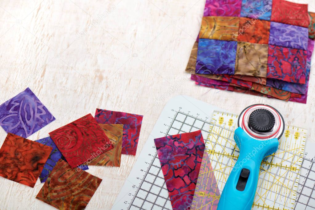Quilting tools, sliced square bright pieces of batik, stack sewn blocks