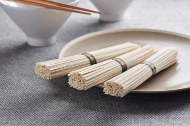 Raw wheat udon noodles on plate, Oriental and Asian cuisine