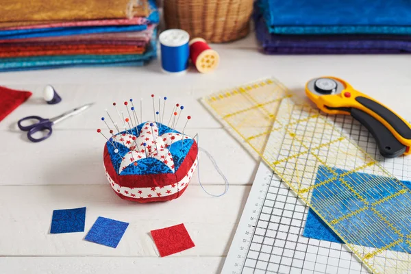 Almofada de alfinete elementos estilizados da bandeira americana, pilhas de tecidos, acessórios de acolchoamento — Fotografia de Stock