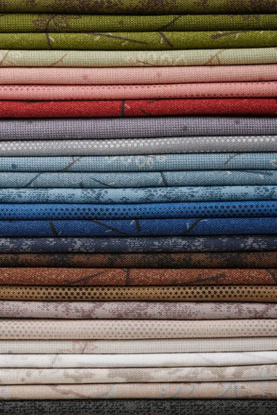 Stack of colorful cotton quilting fabrics as a background image — Stock Photo, Image