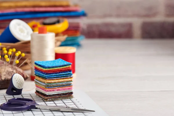 Stack of square pieces of colorful fabrics, accessories for quilting — Stock Photo, Image