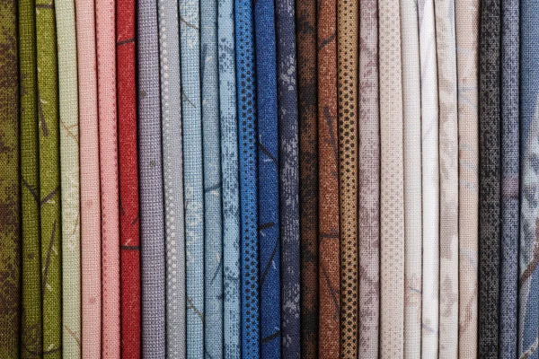 Stack of colorful cotton quilting fabrics as a background image — Stock Photo, Image