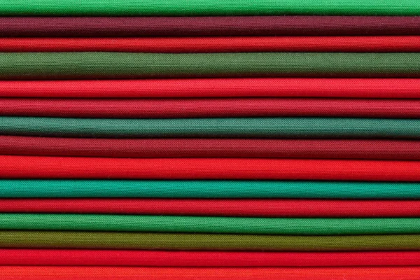 Stack of red and green fabrics as a vibrant background image — Stock Photo, Image