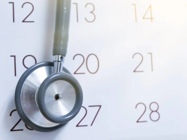 Blue stethoscope on white calendar,check up,follow up