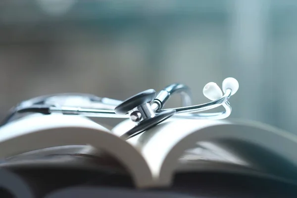 Stethoscope on medical textbooks in library