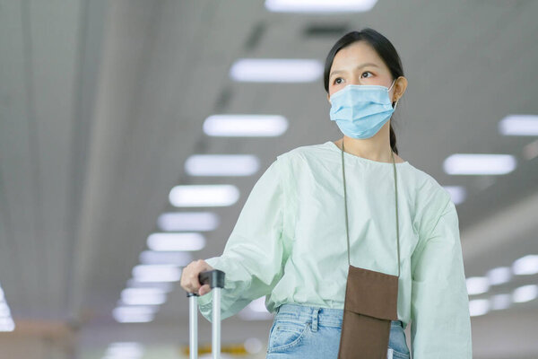 Asian travelers girl with medical face mask to protection the Covid-19 in airport