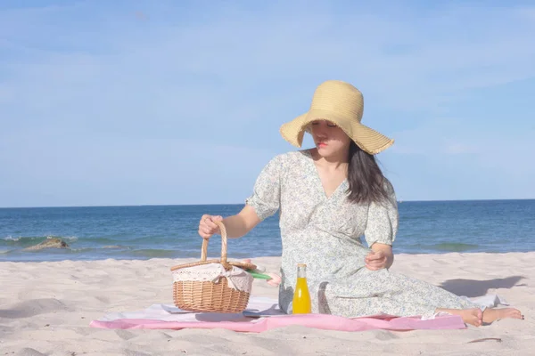 Asian  women picnic on the beach
