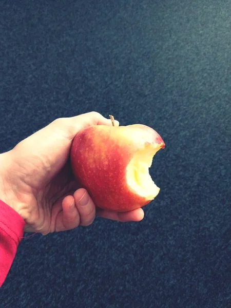Ruka Drží Červené Jablko Tmavém Pozadí — Stock fotografie