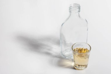 açık arka planda içki ile boş şişe ve cam yakın görünümü