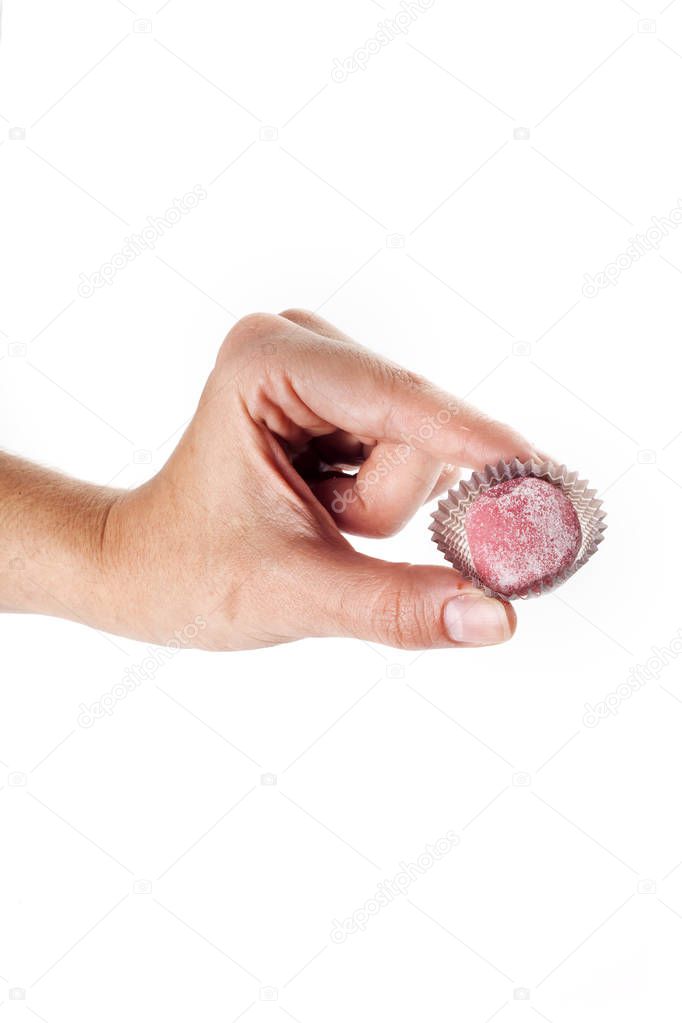 partial view of person holding sweet candy isolated on white backdrop