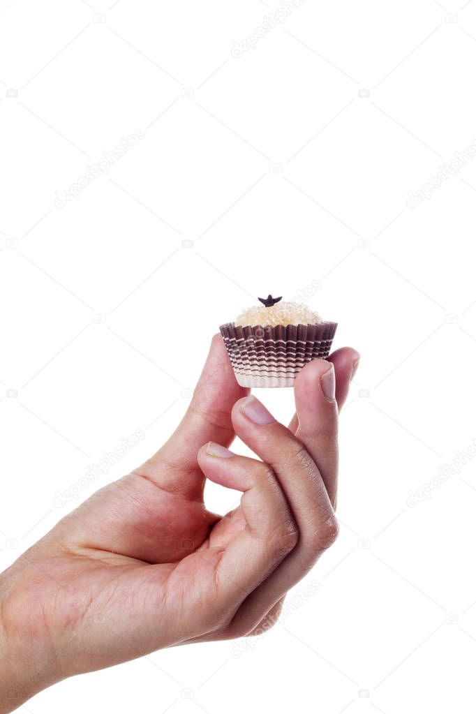 partial view of person holding sweet candy isolated on white backdrop