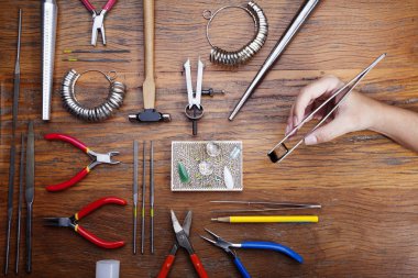 Kuyumcular takı işyerinde araçları üst görünümü. Profesyonel araçlar la zanaat takı yapmak için Masaüstü. rustik ahşap arka plan üzerinde araçlar