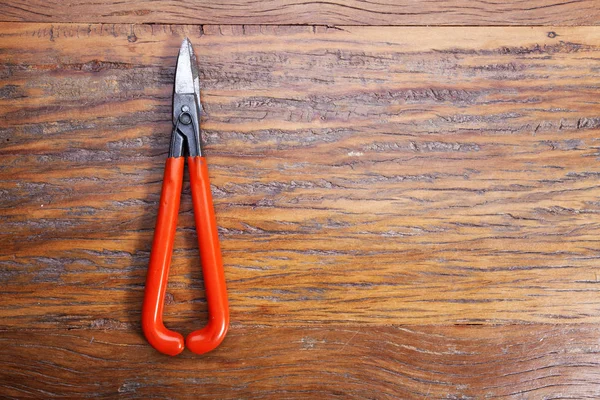 Pliers on the jewelry workplace. Jeweler at work in jewelry. Desktop for craft jewelry making with professional tool. Close up view of tool