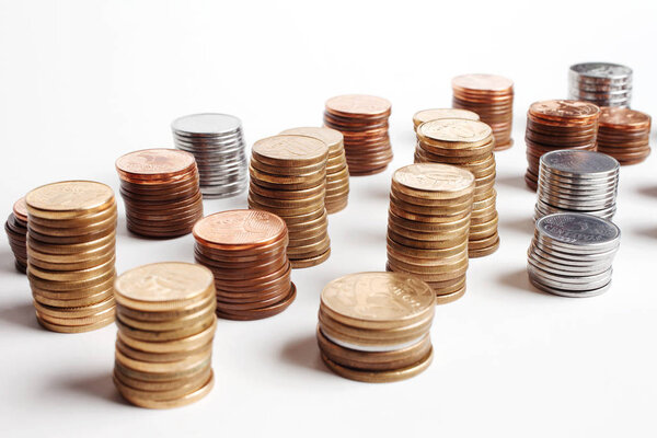 stacks of silver and golden coins isolated on white background, financial concept 