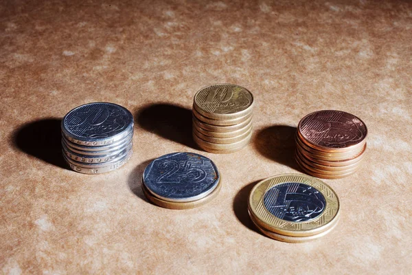 stacks of coins isolated on brown background, financial concept