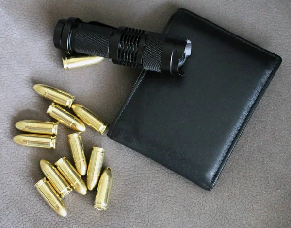 Tactical flashlight  pistol bullets and wallet — Stock Photo, Image