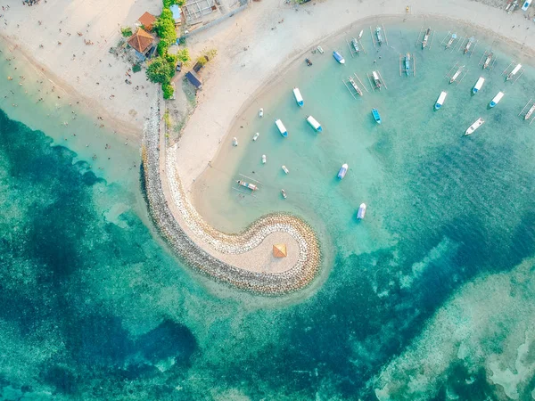 Aerial drone view of ocean, boats, beach, shore In Sanur Beach, Bali, Indonesia with with Traditional Balinese Fishing Boats amazing blue ocean