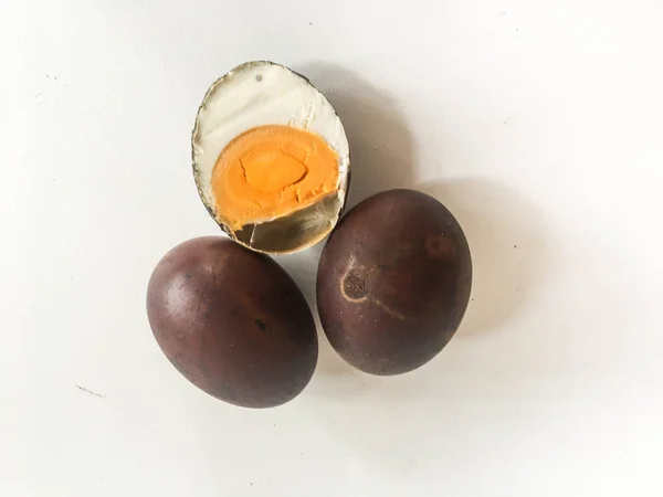 Telur asin Asap or Smoked salted eggs isolated on white background. food culinary from indonesia, black color smoked salted eggs. Indonesian culinary