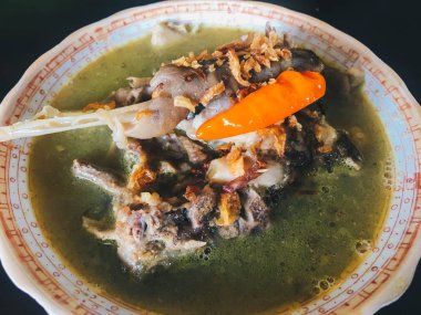 Tengkleng, ne kadar iyi. kaburga ve kemik çorba ile pişirilen keçi eti. Endonezya Geleneksel Gıda Barbekü Kuzu Kemiği siyah ahşap arka plan üzerinde izole yapılmış