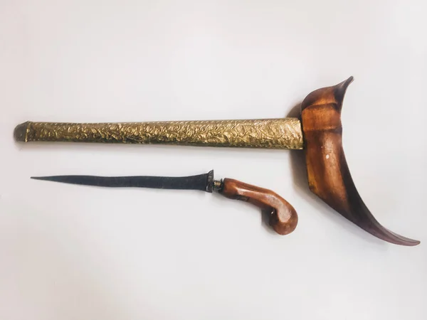 Antique typical Indonesian kris knife with case on white background