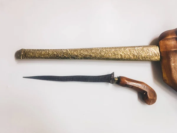 Antique typical Indonesian kris knife with case on white background