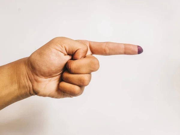 One finger or index finger of hands of a woman who is isolated on a white background. Purple ink spots from the voters\' fingers gave evidence of Indonesian elections. Sign for Jokowi supporter