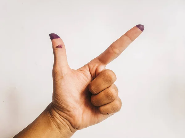 One finger or index finger of hands of a woman who is isolated on a white background. Purple ink spots from the voters' fingers gave evidence of Indonesian elections. Sign for Jokowi supporter