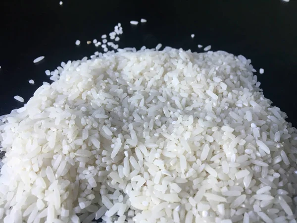 close up of raw rice from Indonesia isolated on black background