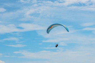 Spor, mavi gökyüzünde kanat uçan yamaçparaşütü