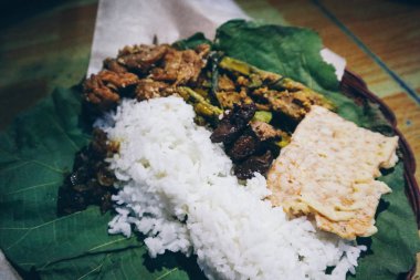 Nasi Jamblang veya Sego Jamblang. Cirebon, Batı Java, Endonezya geleneksel pirinç yemeği. Kokulu tik yaprağına sarılmış ve bol camı ile servis edilen buğulanmış pirinç