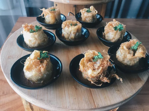 asian appetizers on small plates, close up