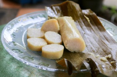Pirinç keki ya da yaygın olarak lontong olarak adlandırılan orta java endonezyasının muz yaprağına sarılı geleneksel yemek tabağına yakın bir fotoğraf.