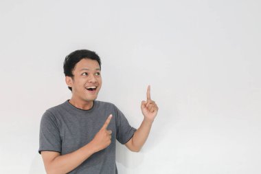 Vay ve şaşırmış yüz, gri tişörtlü, eli boş Asyalı bir adamın gülüşü..