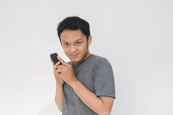 Asian Man Serious Face Sharp Looking Hiding Phone Gesture Isolated — Stock Photo, Image