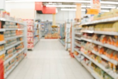 Blurry shot of a grocery store aisle filled with various products.