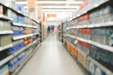 Blurry shot of a grocery store aisle filled with various products.