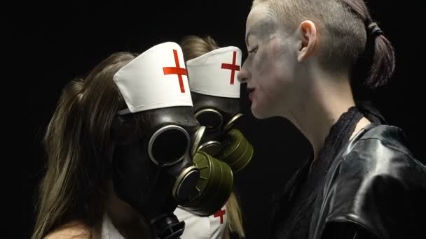 Woman in black and two girls in gas mask — Stock Video