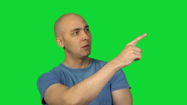 Kel adam yeşil arka plan üzerinde işaret
