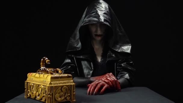 Woman in black hood with horror box — Stock Video