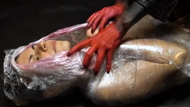 Wrapped woman and red hands — Stock Video