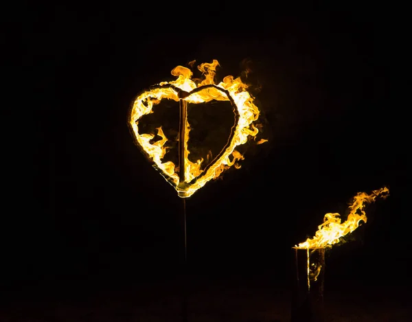 Yellow burning handmade heart on black background — Stock Photo, Image