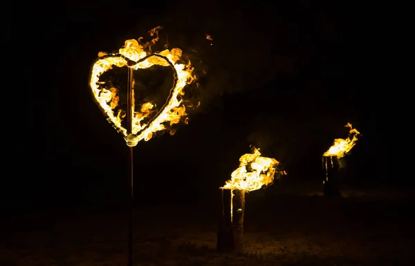 Burning heart andyellow fire on black background — Stock Photo, Image