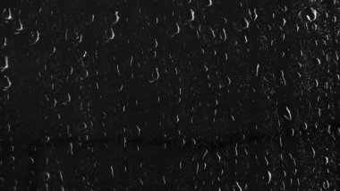Siyah arka plan üzerine su yüzeyine düşer