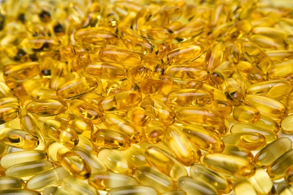 Fond photo d'huile de poisson jaune saine en capsules — Photo