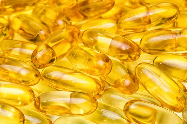 Image de fond de jaune huile de poisson saine dans les pilules — Photo
