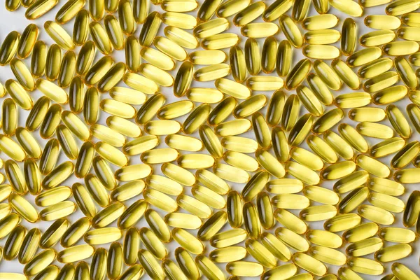 Afbeelding achtergrond gele gezonde vitamine d in capsules — Stockfoto