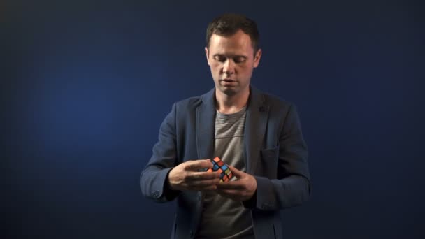 Illusionist man with Rubiks cube — Stock Video